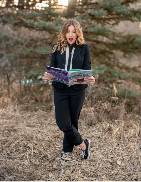 Jordan Hayes reading a Woven Reading book outdoors